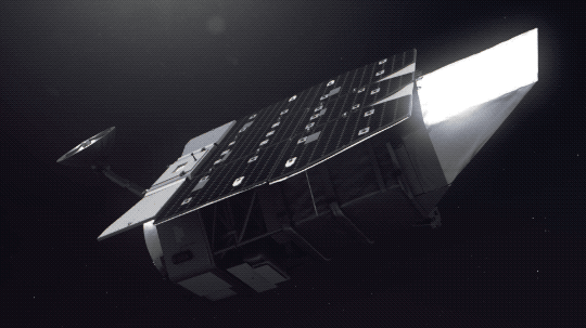 This animation shows an artist’s concept of the Nancy Grace Roman Space Telescope against a black backdrop. The telescope is mostly silver and roughly cylindrical, with a shiny rectangle of solar panels on top and a small antenna extending from near one end. As Roman turns, we can see its primary mirror inside, ready to observe the universe. 