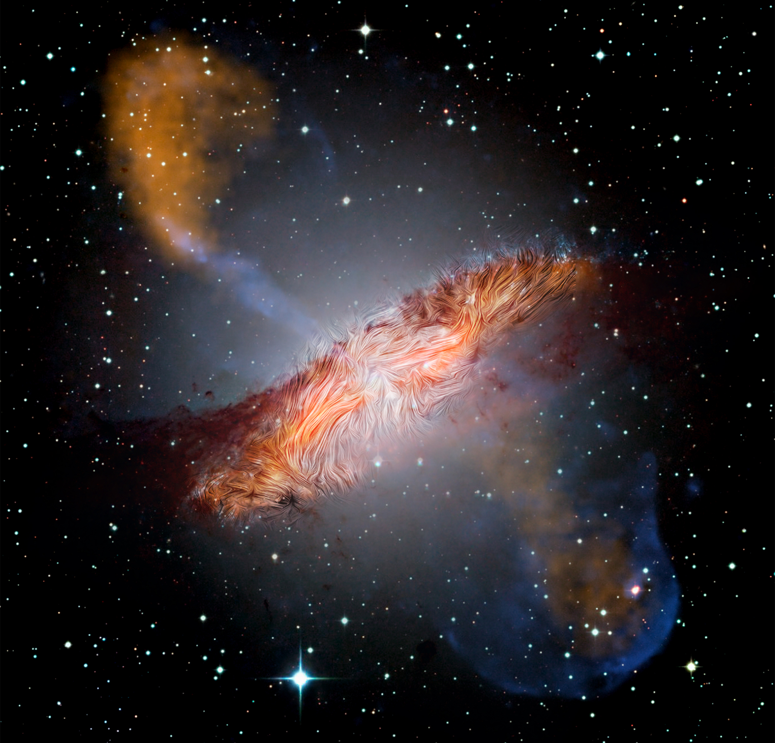 In the center of a black, starry background is a galaxy with two long jets. The galaxy shown in shades of white, orange, and brown looks like a thick pancake tilted to the left. The pancake appears furry with lines representing magnetic information from SOFIA embedded in the disk of the galaxy. From the center of the pancake, above and below it, are two plumes of orange that look like steam rising from a hot cup of tea.