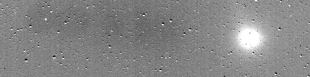 On a gray background a bright ball of light travels across the image from the right side to the left, at a slight angle upward. There are also other small dots sprinkled throughout the image, which mostly remain stationary throughout.