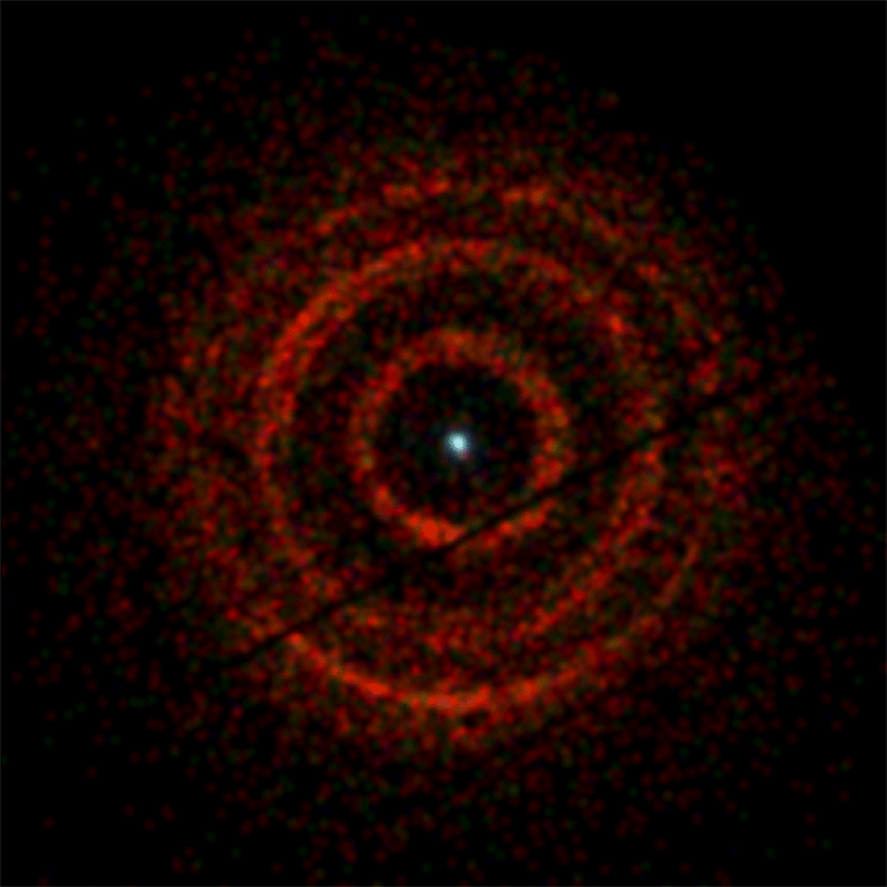 This animated GIF shows rings of X-rays, shown in red, that expand away from a central white dot, like a bullseye target.