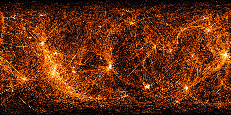 On a black background are a network of orange filaments connecting a number of bright spots. The bright spots indicate places where the filaments cross, and are sources in the sky where NICER often points its telescope. The swirling loops between those points reveal the path NICER’s telescope takes between these sources.